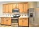 Kitchen features stainless steel appliances, wood cabinets, and tiled backsplash at 3620 Cole Mill Rd, Charlotte, NC 28270