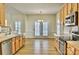 Spacious kitchen with wood cabinets, stainless appliances, eat in area, and doors to the patio at 3620 Cole Mill Rd, Charlotte, NC 28270