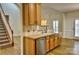 Bright kitchen featuring wood cabinets, stainless steel dishwasher, and tile backsplash at 3620 Cole Mill Rd, Charlotte, NC 28270