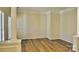 Spacious living room with hardwood floors, white columns, trim, and ample natural light at 3620 Cole Mill Rd, Charlotte, NC 28270