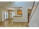 Open-concept living space with hardwood floors, stairs, a dining area, and a glimpse of the kitchen at 3620 Cole Mill Rd, Charlotte, NC 28270