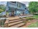 Inviting back deck features brick stairs, outdoor seating, and access to the home's interior at 405 Northwest Dr, Davidson, NC 28036