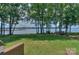 Expansive backyard with mature trees, a foot bridge, and stunning lake views at 405 Northwest Dr, Davidson, NC 28036