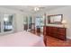 Bright main bedroom features lake views, rocking chair, and hardwood floors at 405 Northwest Dr, Davidson, NC 28036