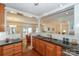 Bright kitchen with granite countertops, wood cabinets, and an open design to the living room at 405 Northwest Dr, Davidson, NC 28036