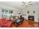 Inviting living room featuring a fireplace, lake views, and comfortable seating arrangements at 405 Northwest Dr, Davidson, NC 28036