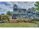 Charming two-story home featuring multiple balconies and a brick patio at 405 Northwest Dr, Davidson, NC 28036