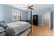 Bedroom features hardwood floor, ceiling fan, and a window with shutters at 4915 Ardenwoods Dr, Charlotte, NC 28215