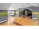 Large bonus room with unique trim, gray walls, a window, and hardwood floor at 4915 Ardenwoods Dr, Charlotte, NC 28215