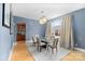 Bright dining room featuring a glass table, six chairs, and a large window with elegant curtains at 4915 Ardenwoods Dr, Charlotte, NC 28215