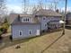 Rear elevation of home showing deck, door to basement, and expansive backyard at 4915 Ardenwoods Dr, Charlotte, NC 28215