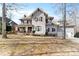 Charming two-story home showcasing beautiful architectural details and a welcoming front yard at 4915 Ardenwoods Dr, Charlotte, NC 28215