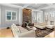Bright living room features stone fireplace, white sofas and plenty of natural light at 4915 Ardenwoods Dr, Charlotte, NC 28215