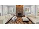 Bright living room features stone fireplace, white sofas and plenty of natural light at 4915 Ardenwoods Dr, Charlotte, NC 28215