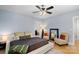 Comfortable main bedroom with a large bed, hardwood floors, and stylish seating area at 4915 Ardenwoods Dr, Charlotte, NC 28215