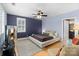 Spacious main bedroom with blue accent walls, hardwood floors, and a large bed at 4915 Ardenwoods Dr, Charlotte, NC 28215