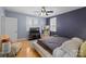 Bright main bedroom featuring hardwood floors, a modern bed, and ample natural light at 4915 Ardenwoods Dr, Charlotte, NC 28215