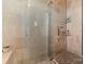 Luxurious walk-in shower features attractive stone tile work and built-in shelving at 4915 Ardenwoods Dr, Charlotte, NC 28215