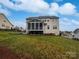 Exterior view of a two story home with a screened in porch overlooking the yard at 509 Riviera Pl, Rock Hill, SC 29730
