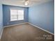 This bedroom features calming blue walls and a ceiling fan at 509 Riviera Pl, Rock Hill, SC 29730