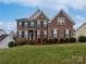 Charming brick two-story home featuring a manicured lawn and classic architectural details at 509 Riviera Pl, Rock Hill, SC 29730