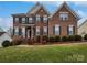 Beautiful two-story brick home featuring black shutters, landscaped yard, and covered front porch at 509 Riviera Pl, Rock Hill, SC 29730