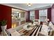 Well-lit living room with dark red walls, a large area rug, and plush white furniture at 509 Riviera Pl, Rock Hill, SC 29730