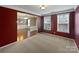 Bright living room with dark red walls, with an archway leading to the dining room at 509 Riviera Pl, Rock Hill, SC 29730