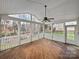 Spacious screened porch with wood floors, a ceiling fan, and views of the backyard at 509 Riviera Pl, Rock Hill, SC 29730