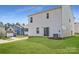 View of the backyard with a manicured lawn and a sliding glass door to the white siding home at 5336 Small St, Catawba, NC 28609