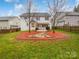 Lush backyard with a well-maintained lawn, patio area, and mature trees for privacy at 6409 Chadwell Ct, Fort Mill, SC 29707