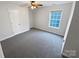 Cozy bedroom with plush carpeting, ceiling fan and a large window at 6409 Chadwell Ct, Fort Mill, SC 29707