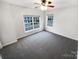Bright bedroom featuring neutral walls, carpet flooring, and a large window for natural light at 6409 Chadwell Ct, Fort Mill, SC 29707