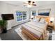 Cozy bedroom with a large window, neutral decor, and soft carpet, creating a relaxing atmosphere at 6409 Chadwell Ct, Fort Mill, SC 29707