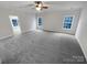 Large bedroom with modern ceiling fan, neutral paint, and a large window at 6409 Chadwell Ct, Fort Mill, SC 29707