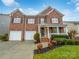 Inviting brick home with a two-car garage, well-kept lawn, and charming front porch at 6409 Chadwell Ct, Fort Mill, SC 29707