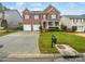 Charming brick two-story home with attached two-car garage and well-manicured front lawn at 6409 Chadwell Ct, Fort Mill, SC 29707