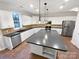 Spacious kitchen with a large center island, stainless steel appliances, and white cabinetry at 6409 Chadwell Ct, Fort Mill, SC 29707