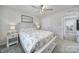 Cozy bedroom featuring a floral bedspread, nightstand, and framed art at 730 Bonica Ct, Lancaster, SC 29720