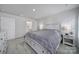 Spacious bedroom with a striped bedspread, nightstand, and bathroom access at 730 Bonica Ct, Lancaster, SC 29720