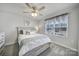 Comfortable bedroom with a striped bedspread, ceiling fan, and window at 730 Bonica Ct, Lancaster, SC 29720