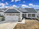 Charming single-story home boasts a well-manicured lawn, attached two-car garage, and inviting entryway at 730 Bonica Ct, Lancaster, SC 29720