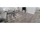 Comfortable living room showcasing wood-look flooring, cozy seating, and natural light at 730 Bonica Ct, Lancaster, SC 29720