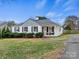 Charming white brick home with a covered front porch and manicured landscaping at 734 Poindexter Dr, Charlotte, NC 28209