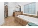 Main bathroom featuring a soaking tub, separate shower, tile floors, and decorative glass at 7674 Bermuda Hills Ln, Denver, NC 28037
