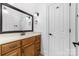 Bathroom featuring a wood vanity with great lighting, and a white painted door to the right at 7674 Bermuda Hills Ln, Denver, NC 28037