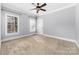 Simple bedroom with neutral carpet, grey paint, windows providing natural light, and ample closet space at 7674 Bermuda Hills Ln, Denver, NC 28037
