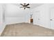 Bonus bedroom with an attached bathroom, neutral carpet, and natural light. White painted at 7674 Bermuda Hills Ln, Denver, NC 28037