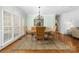 Elegant dining room with decorative mirror, hardwood floors, decorative rug, and classic chandelier at 7674 Bermuda Hills Ln, Denver, NC 28037