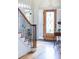 Foyer with wood staircase and hardwood floors leading into other parts of the house, neutral paint at 7674 Bermuda Hills Ln, Denver, NC 28037